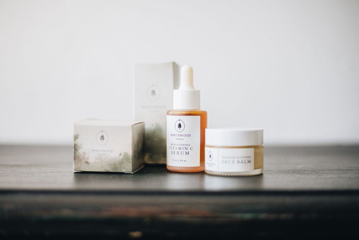 Minimalist flat lay of a complete skincare routine - serum and balm on a neutral surface