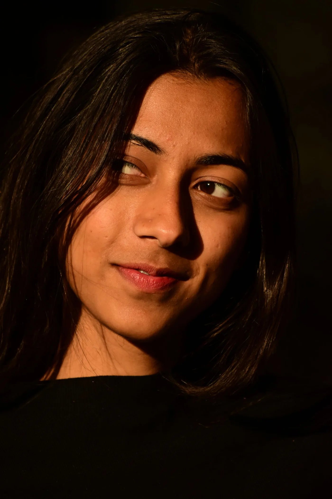 Woman with glowing skin in warm evening sunlight