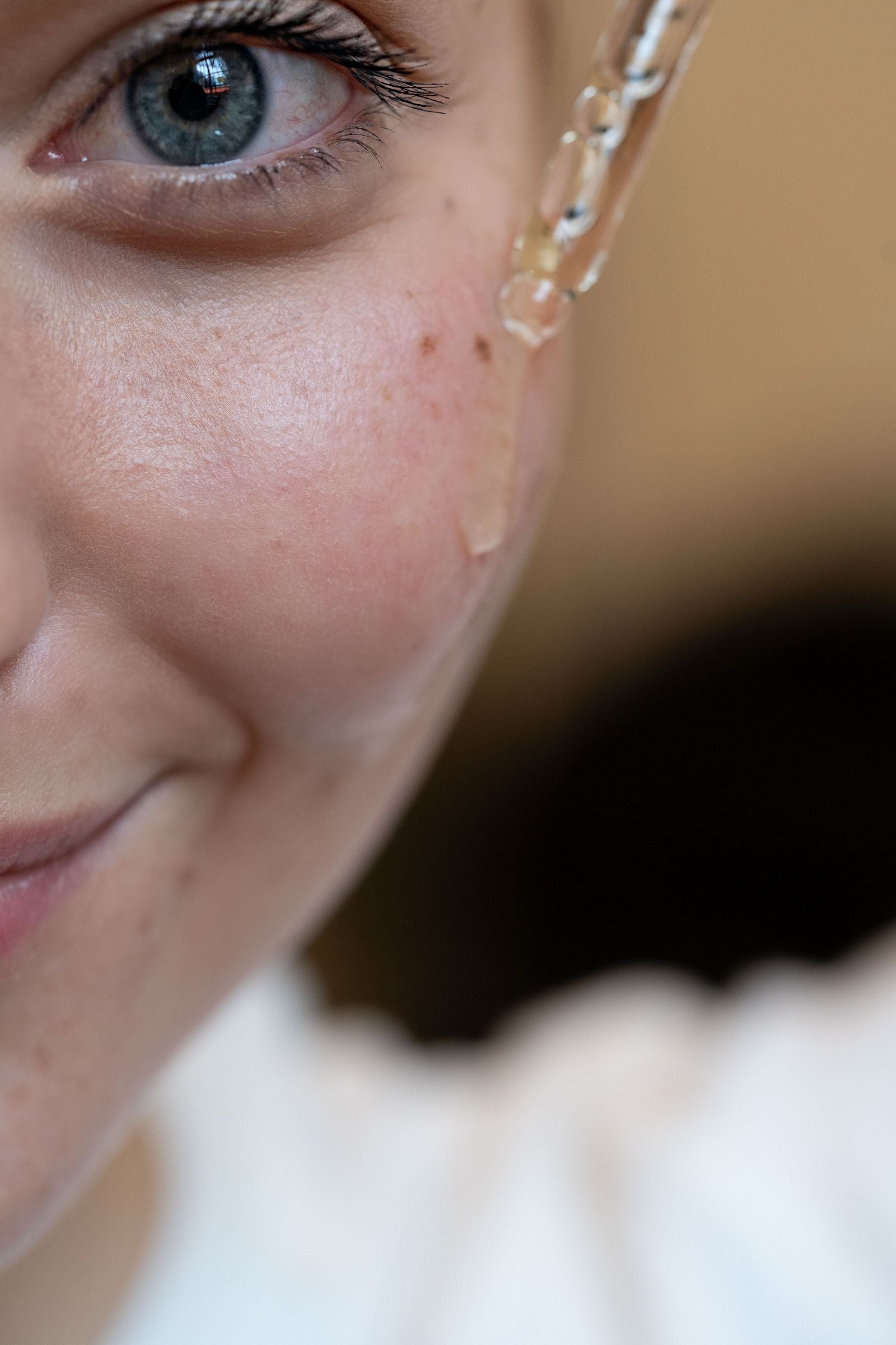 Woman applying brightening serum